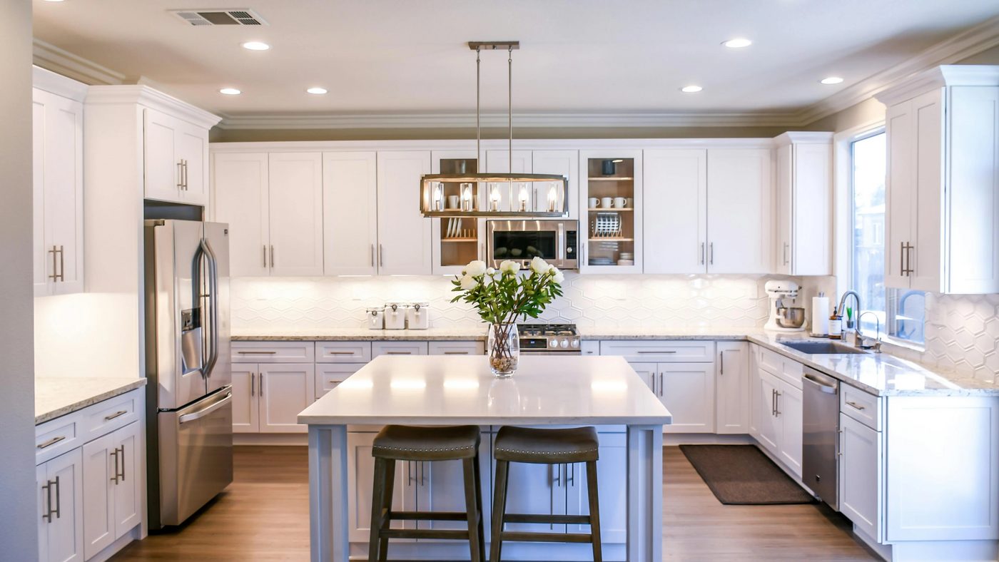 Sparkling white kitchen with island, cleaned to a show-home finish